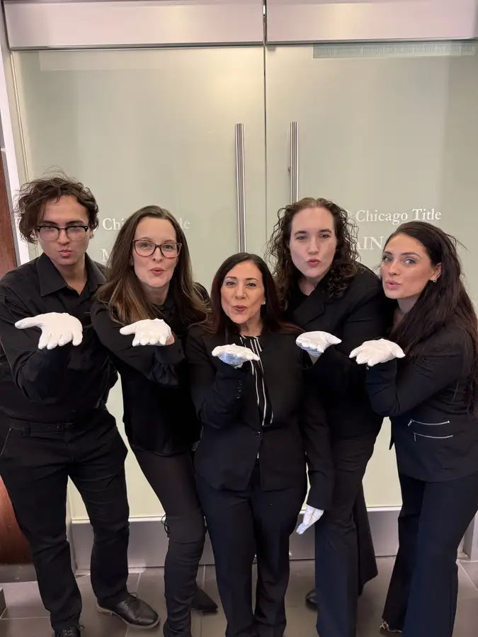 Team in white gloves blowing kisses